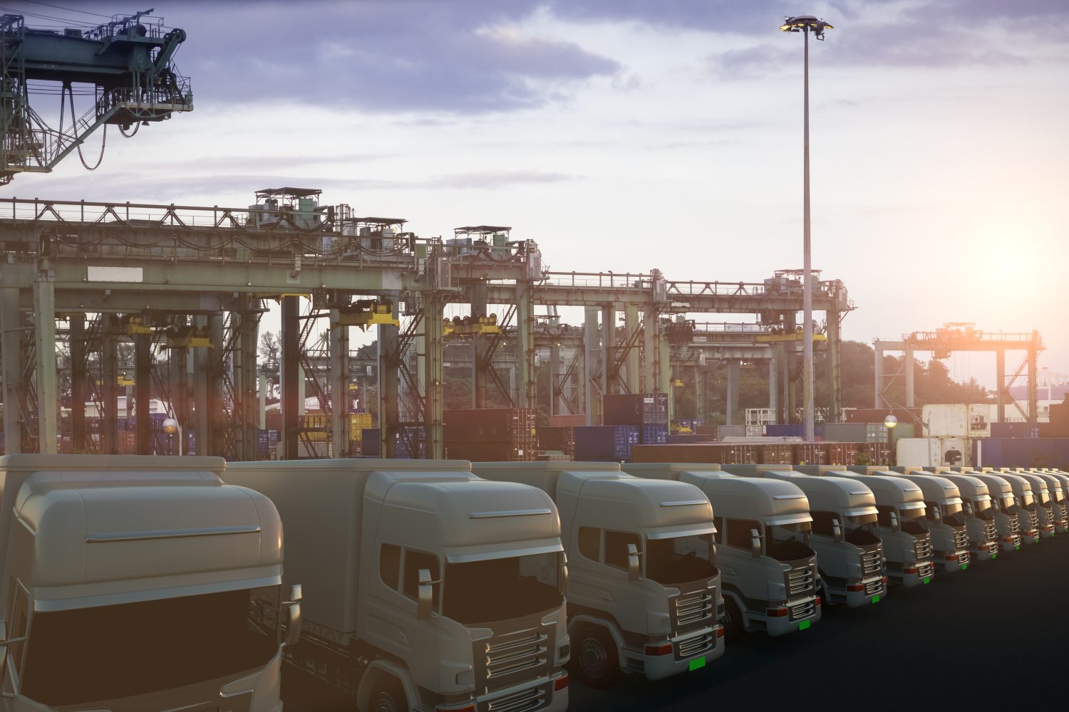 Row of cargo electric trucks against with sun